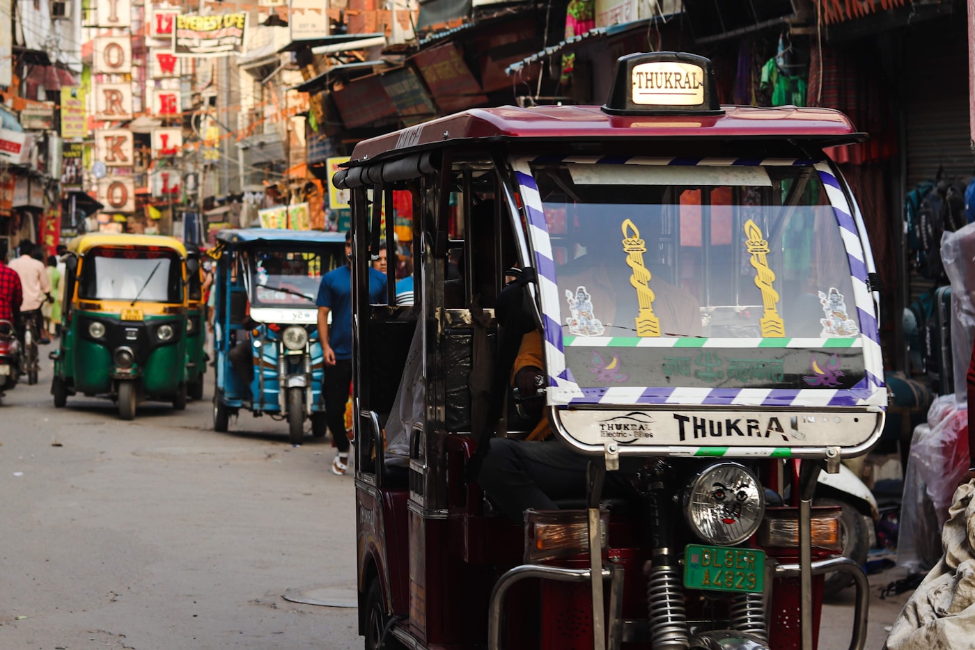 Auto rickshaw on a busy Indian street, representing e-rickshaw and passenger fleet use